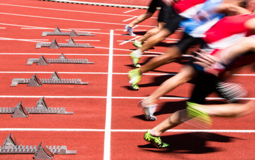 athletes in sprint start in track and field