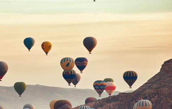 Mountain landscape with large balloons in a short summer season at dawn.