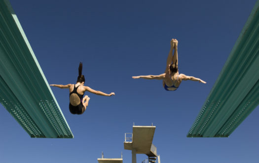 Two women diving from diving board